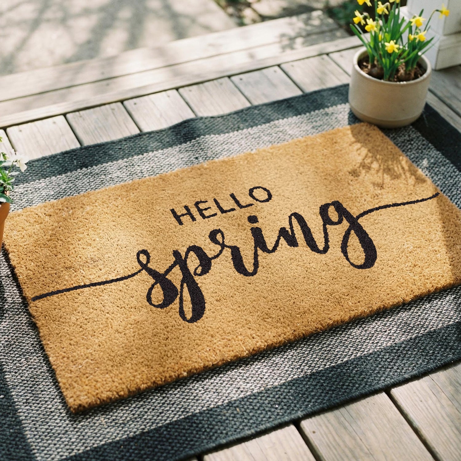 Hello Spring doormat in natural tan coir with script lettering, placed at [location context]