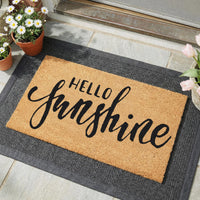 Hello Sunshine doormat in natural coir with bold script lettering, showing [specific detail]