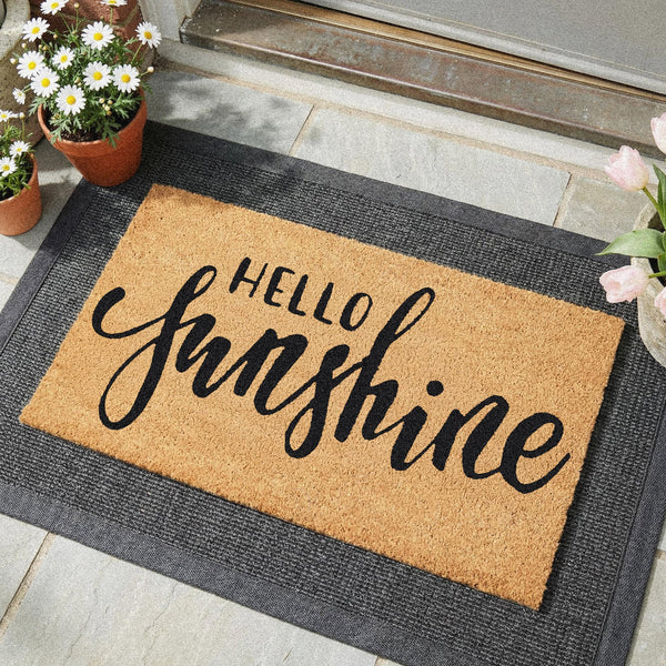 Hello Sunshine doormat in natural coir with bold script lettering, showing [specific detail]
