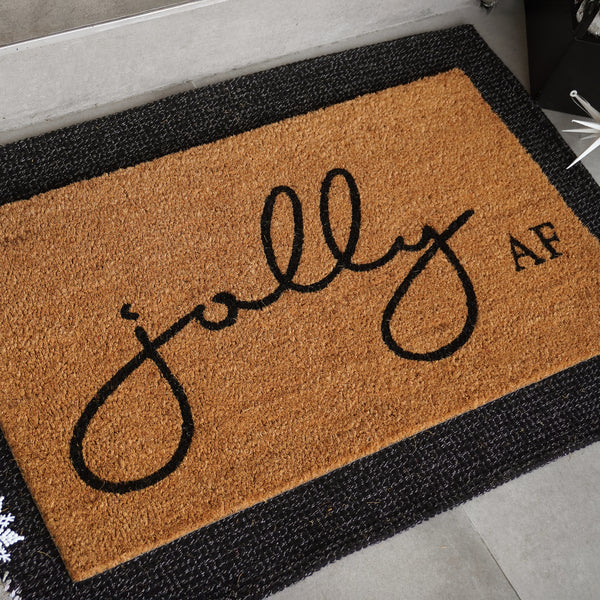 Jolly AF natural coir doormat with black script and bold lettering on tan coconut fiber background, shown