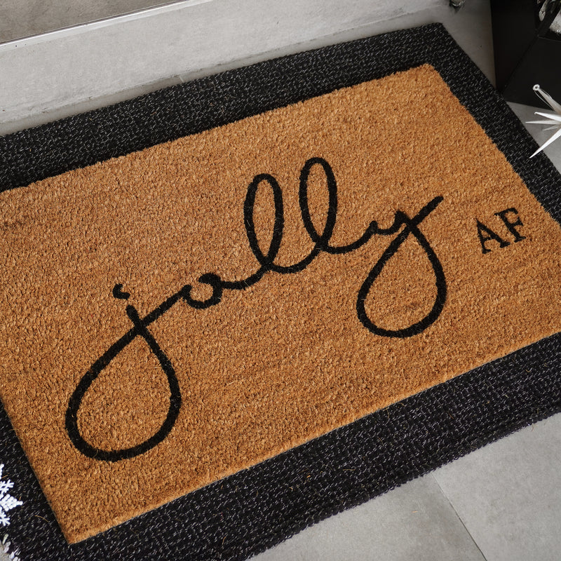 Jolly AF natural coir doormat with black script and bold lettering on tan coconut fiber background, shown