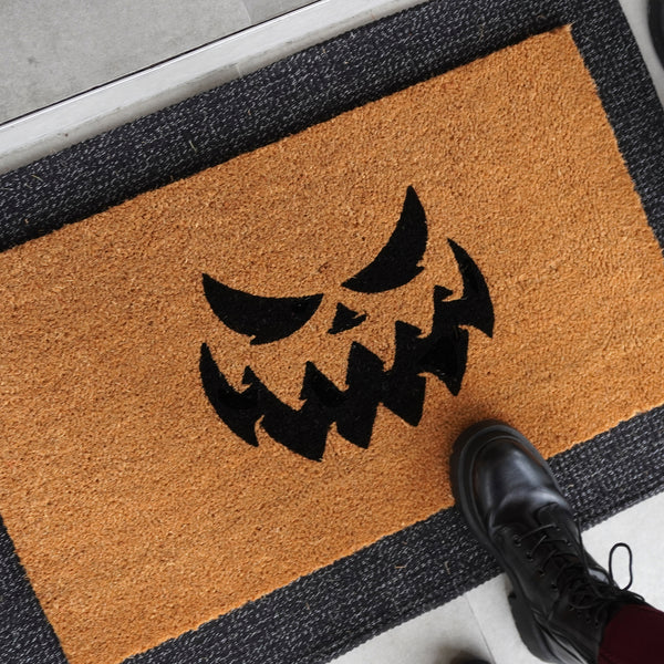 Spooked jack-o'-lantern doormat in natural coir, Theodore Magnus